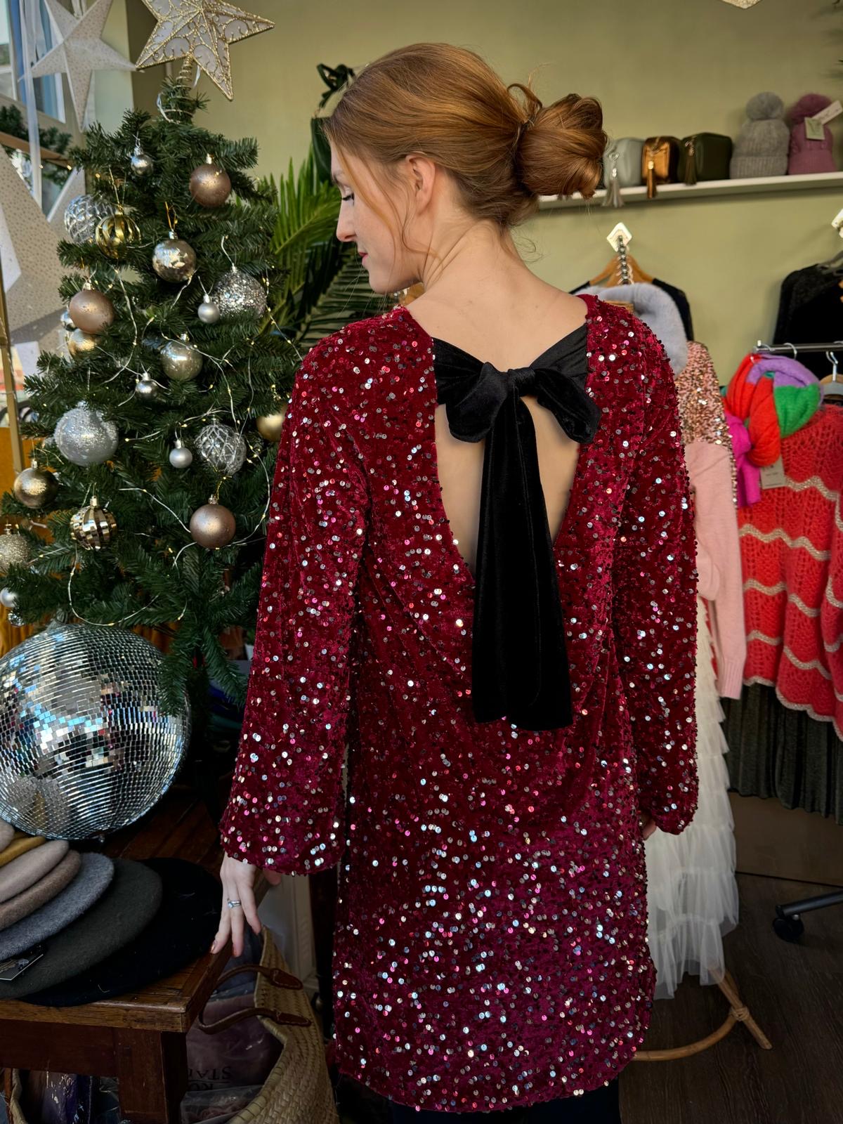 Red knee length sequin party dress with large black velvet bow 